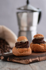 biscuits with chocolate filling.submitted on a wooden board.On the backdrop of a coffee maker, and a mix with coffee
