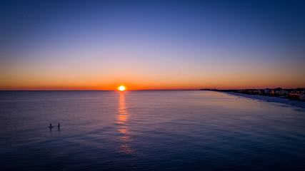 Beautiful aerial sunset view of gulf of mexico near 30A with paddleboard