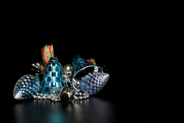 Fototapeta premium Christmas decorations with bells, on a black background.