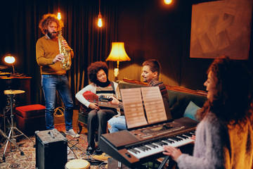 Multicultural jazz band practicing for the gig in home studio.