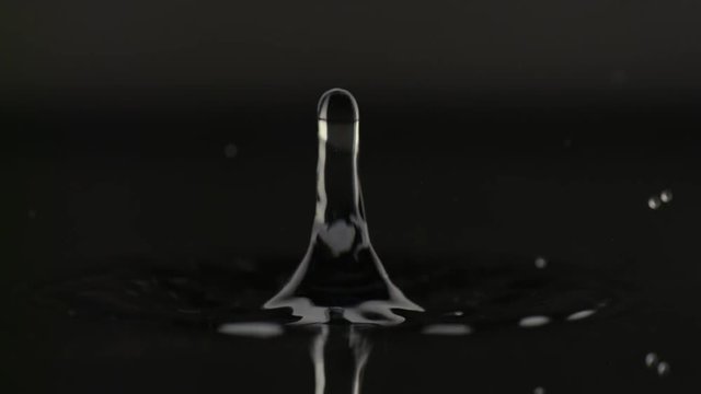 Beautiful drop of water bouncing off water surface in slowmotion HD