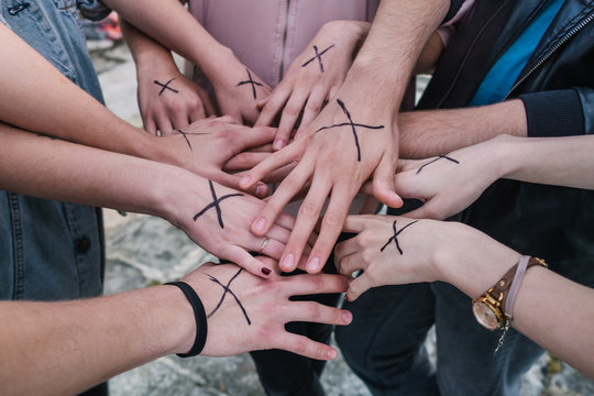 Anonymous group of teenage friends with streight edge sign on their hands 