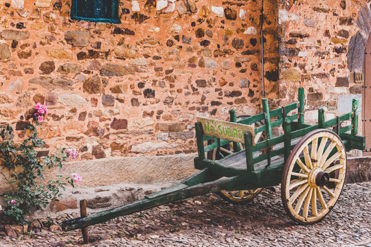 Empty bullock cart by the stone house in Castrillo de los Polvazares ancient village. Leon, Castilla Spain
