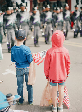 kids gathering candy at fourth of july parade