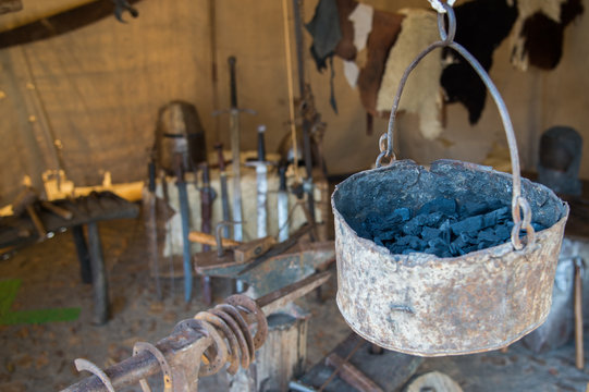 
Weapons and swords in the shop of a medieval blacksmith