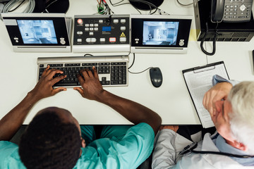 Doctors using computer for procedure