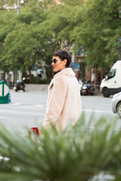 Stylish short haired business woman commuting between meetings on a busy city