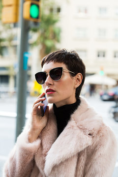 Stylish short haired business woman commuting between meetings on a busy city