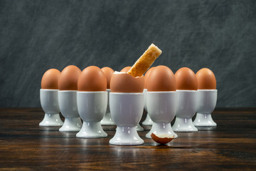 Toast Soldier Dipped Into Boiled Egg in Egg Cup on a Table