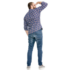 A man in jeans looks into the distance on a white background. Isolation