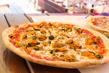 Appetizing italian seafood pizza. Fresh delicious pizza with mussels