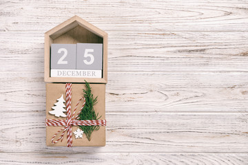 Calendar with date 25 december and gift boxes on color background. Christmas vintage, toned concept