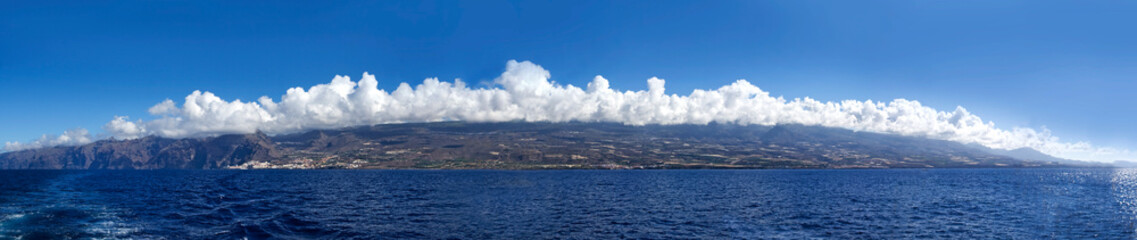 Fototapeta na wymiar Tenerife Island in the clouds from the open ocean