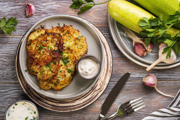 zucchini fritters on wooden table