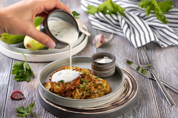 zucchini fritters on wooden table