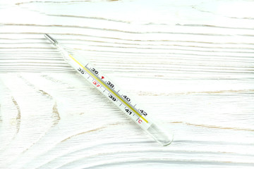 medical thermometer on wooden background