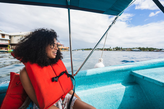 Young smiling lady on boat near water