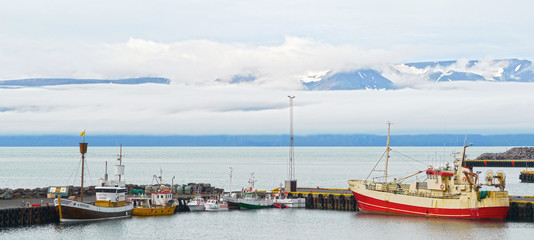 Fototapeta na wymiar Husavík / Iceland - August 2010: Fishing ships at the harbour
