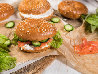 Fresh homemade bagel sandwiches with smoked salmon and low fat cream cheese. Healthy breakfast food on rustic wooden background