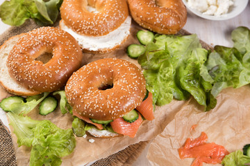 Fresh homemade bagel sandwiches with smoked salmon and low fat cream cheese. Healthy breakfast food on rustic wooden background