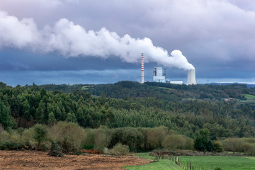 Environmental pollution problem concept. Coal power plant polluting the planet. Thick chimney smoking towards the sky. Meirama coal power plant, Galicia Spain