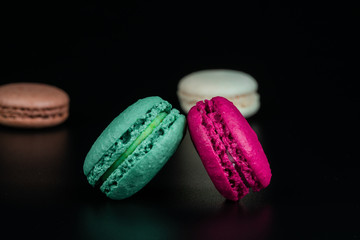 colorful macaroons on black background