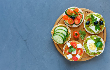 Assorted canapes, appetizers or tapas on a board