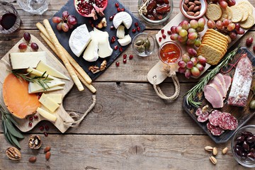 Brunch. Appetizers table with various of cheese, curred meat, sausage, olives, nuts and fruits. Festive family or party snack concept. Overhead view.