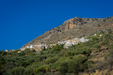 Fototapeta na wymiar Agios Nikolaos, Crete - 09 28 2018: A village in the hill