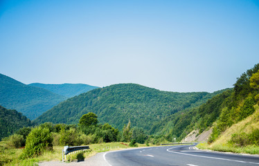 The road to the mountains. Mountain landscape on a summer day.