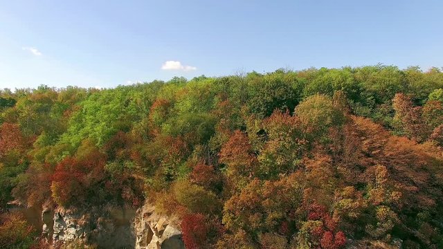 4K aerial view of autumn forest, forest and rocks in autumn, flying over buky canyon in the autumn, Picturesque view on Buky Canyon, Cherkasy region, Ukraine