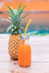 Fresh yellow pineapple tropic fruit summer refreshment smoothie shake drink near pool