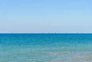 Seascape summer day with the bright blue sky and many sailboats in the sea. Interior photo