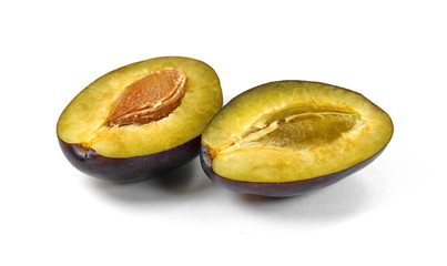  Plums cut in half isolated on white background