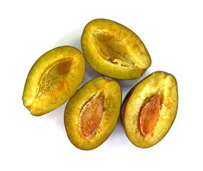  Plums cut in half isolated on white background