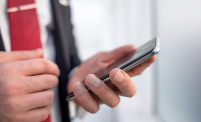 close up.businessman reading text message on smartphone