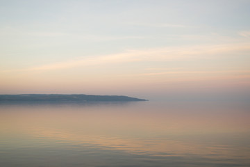 Fototapeta premium Background of mist on sunset over lake. Composition of nature.