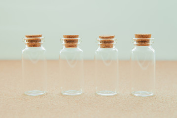Empty little bottles with cork stopper on white background