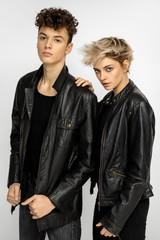Sexy fashionable couple in black leather jacket isolated on white background