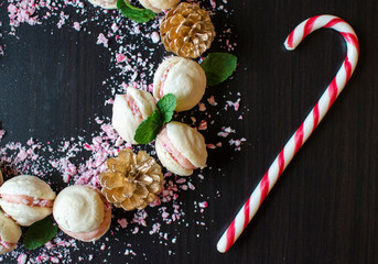 French Macaron Festive Sweets with Candy Cane and Gold Pine Cone