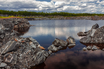 summer landscape of artificial lake in abandoned former marble stone mine, Karelia, Russia
