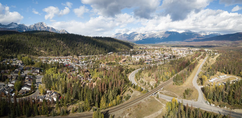 Aerial panoramic view of Residential homes in a small alpine town during a cloudy day. Taken in Jasper, Alberta, Canada.