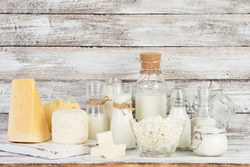 Fermented milk products: milk, kefir, sour cream, cottage cheese, butter, cheese on a white wooden table