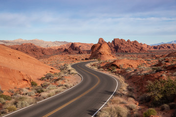 Scenic view on the road in the desert during a cloudy and sunny day. Taken in Valley of Fire State Park, Nevada, United States.