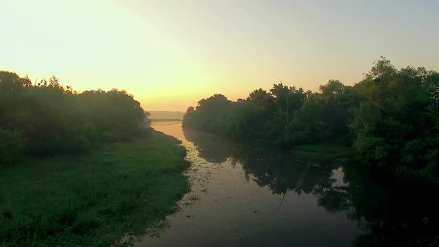 aerial view of river at sunrise 4K, fly over morning mist on the river, Very high view of the river at sunrise, Aerial view of mystical river at sunrise with fog, sun above the river aerial