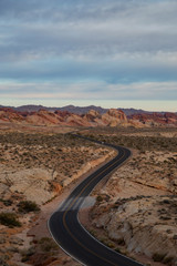 Aerial view on the scenic road in the desert during a cloudy sunrise. Taken in Valley of Fire State Park, Nevada, United States.