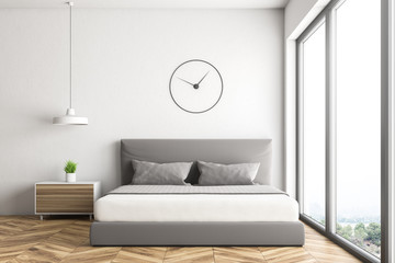 White loft bedroom with clock