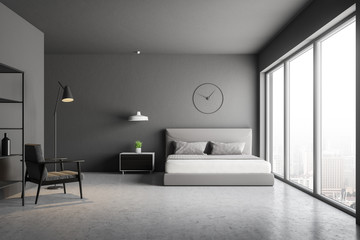 Gray bedroom with clock and armchair