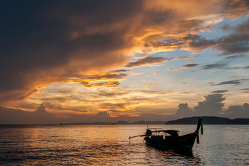 Long tail fishing boat at sunset, Koh Phi Phi, Thailand.