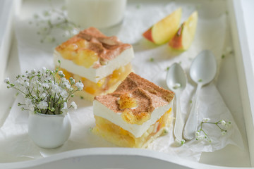 Closeup of apple pie with apples and cream